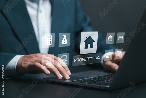 Property Tax concept. real estate management. person use laptop with property tax icon on virtual screen.