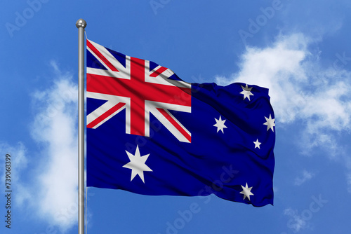 Australia flag fluttering in the wind on sky.