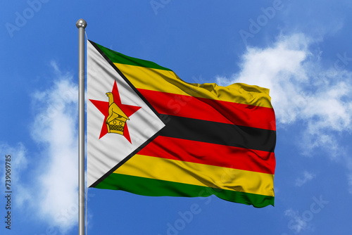 Zimbabwe flag fluttering in the wind on sky.
