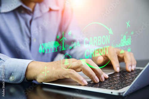 Carbon Credit Market and Net zero concept. Businessman using laptop analyzing carbon credit data Icon energy and environmental protection round. neutral zero carbon greenhouse gas emissions.