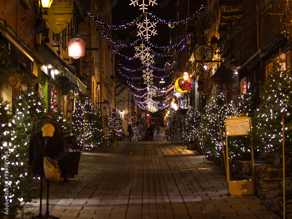 outdoor christmas decorations on a cobblestone street in old quebec city
