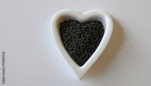  Heart-shaped container filled with black beads