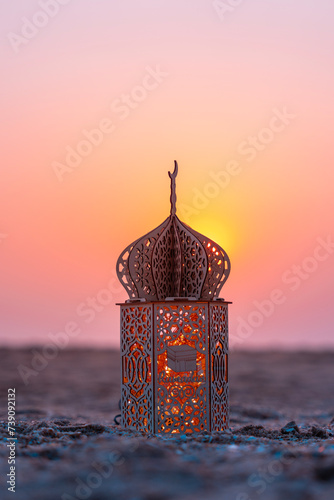 Islamic concept image, Beautiful lantern on the beach with sunset sky, Ramadan Kareem background