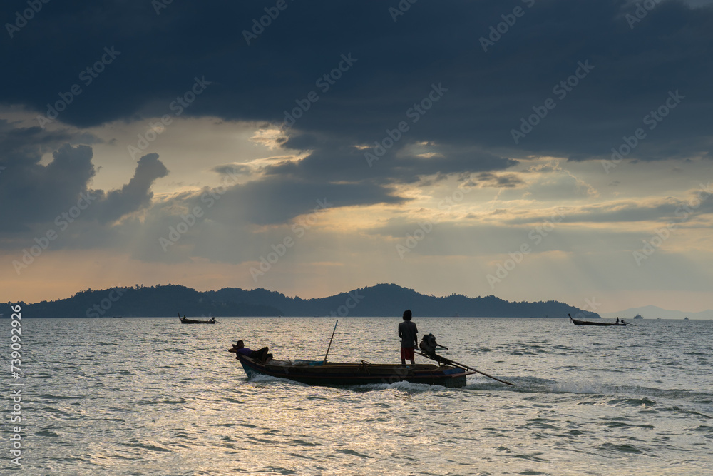 fisherman on longboat reflection on water