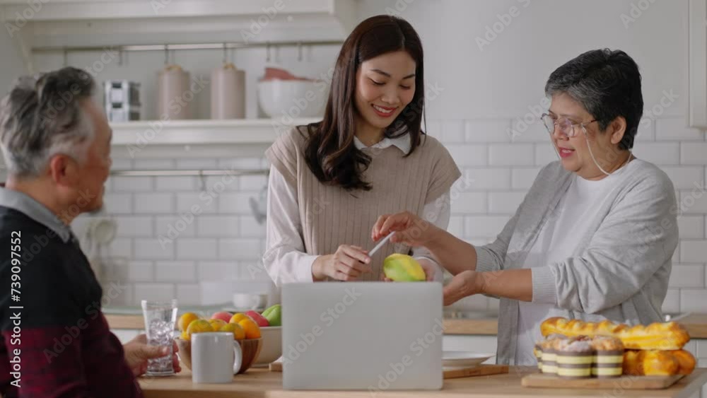 Happy mature old couple of parents and daughter cooking family dinner in kitchen,Mother teaching daughter to peel fruit,enjoying leisure,holiday,culinary hobby,active enjoy family retirement weekend. Happy mature old couple of parents and daughter cooking family dinner in kitchen,Mother teaching daughter to peel fruit,enjoying leisure,holiday,culinary hobby,active enjoy family retirement weekend.