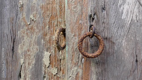 Rustic old wooden door and iron lock ring.