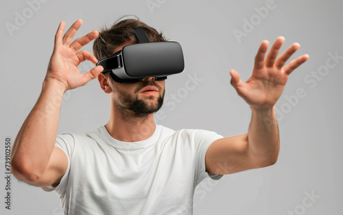 handsome man in vr glasses, playing with virtual reality headset, trying to touch something with hand