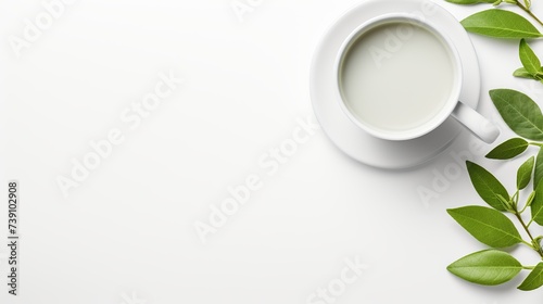 Top view mockup a cup of tea and tea leaf on the white desk. Free space for your text