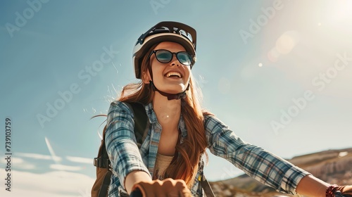 A girl rides a bicycle in the mountains. Cross-country cycling, Rocks and mountains all around