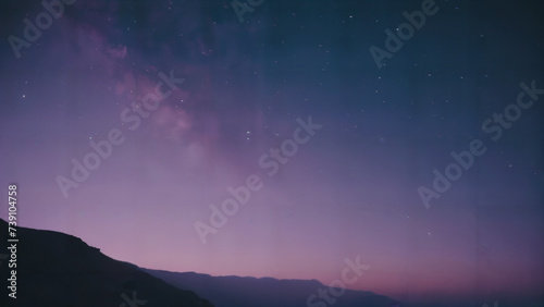 purple and blue sky with stars and a mountain in the background