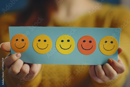 Hands holding happy smile face for medical care concept. face happy, sad, and angry person, mental health positive thinking.