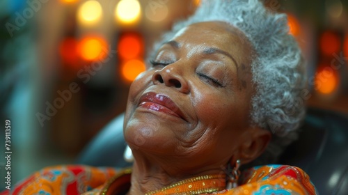 Mature African-American woman in a peaceful spa setting, eyes closed in relaxation, embodying tranquility and self-care.