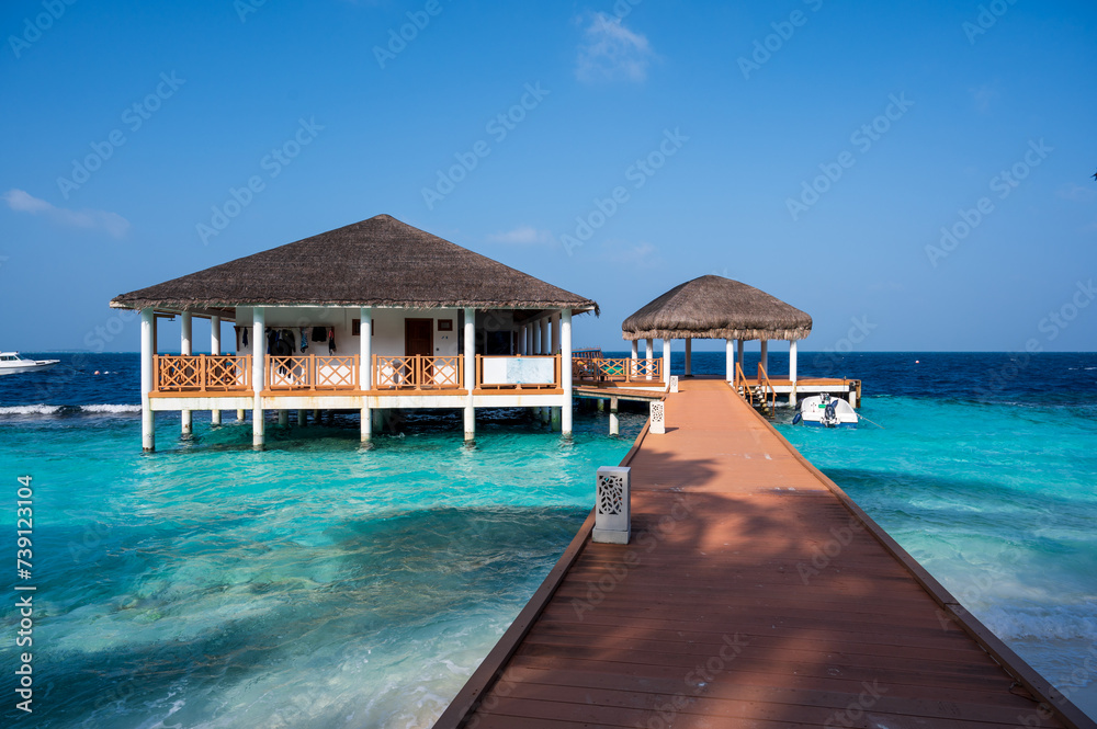 Tropical building and shelter above the sea. Wooden bridge.