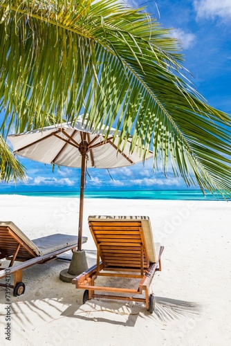 Beautiful tropical beach leisure banner. Couple chairs umbrella white sand coco palm trees travel honeymoon wide panorama background. Amazing landscape. Luxury island resort vacation, sunshine sea sky