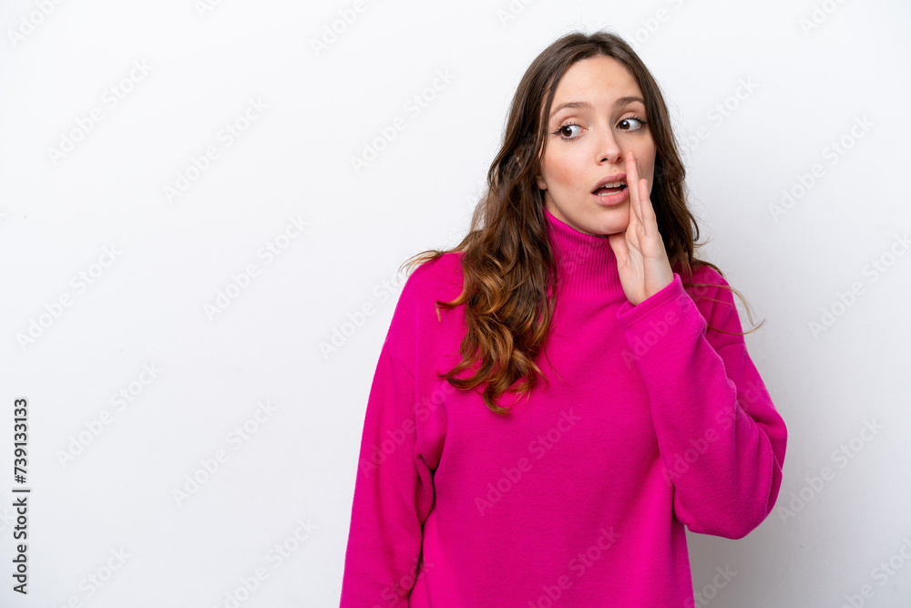 Fototapeta premium Young caucasian woman isolated on white background whispering something with surprise gesture while looking to the side