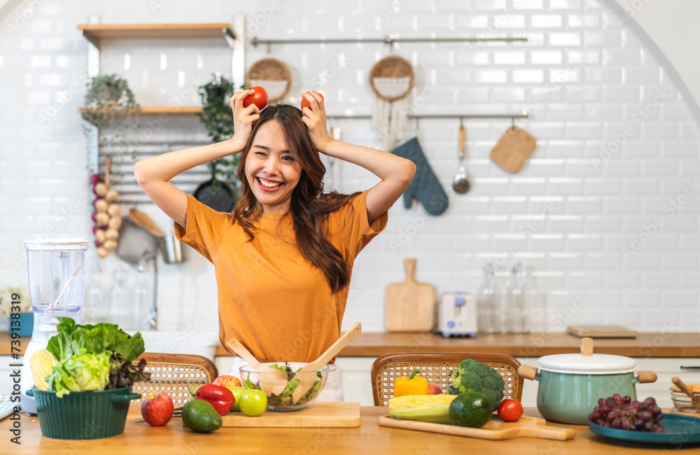 Portrait of beauty health asian woman having fun hold tomato cooking, vegan food healthy eat, fresh vegetable, Lycopene, vitamins, skincare, vegetarian in kitchen.Diet.Fitness, healthy food Portrait of beauty health asian woman having fun hold tomato cooking, vegan food healthy eat, fresh vegetable, Lycopene, vitamins, skincare, vegetarian in kitchen.Diet.Fitness, healthy food