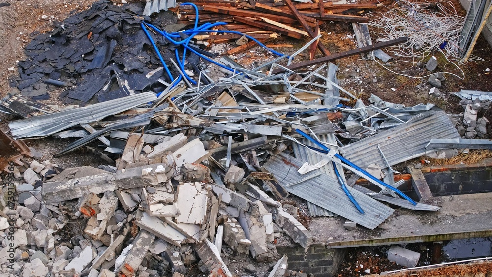 Heavy Machinery Equipment and Pieces of Cinder Block Concrete Rubble and Construction Waste at Building Demolition Site Heavy Machinery Equipment and Pieces of Cinder Block Concrete Rubble and Construction Waste at Building Demolition Site