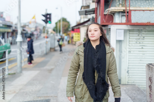 A woman in her 20s walking in the city of Hong Kong's New Territories 香港新界の街を歩く20代の女性 photo