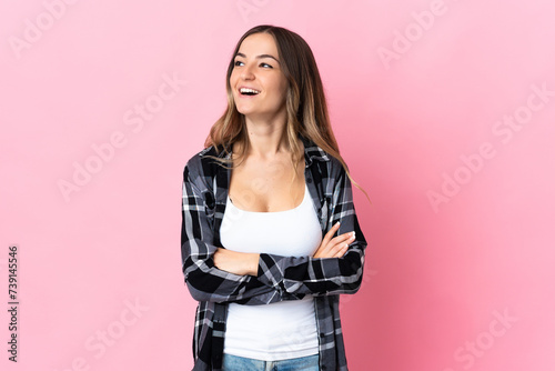 Young Romanian woman isolated on pink background happy and smiling