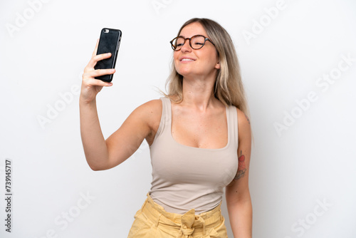 Young Rumanian woman isolated on white background making a selfie