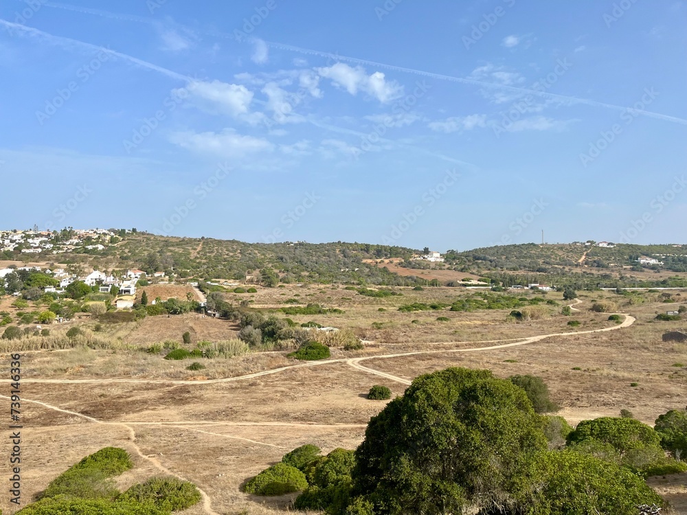 Hiking pathways at the ocean coast valley, aerial view to the small town at the ocean coast