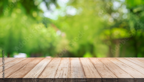 Empty wood table top on blur abstract green from garden and house background. For montage product display