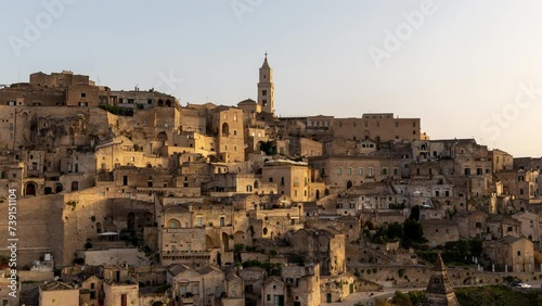 Matera Italy timelapse - old stone houses and caves on a hill at sunset or sunrise. Skyline time lapse of historical village (town) and UNESCO heritage in Europe in the evening (night) or morning.