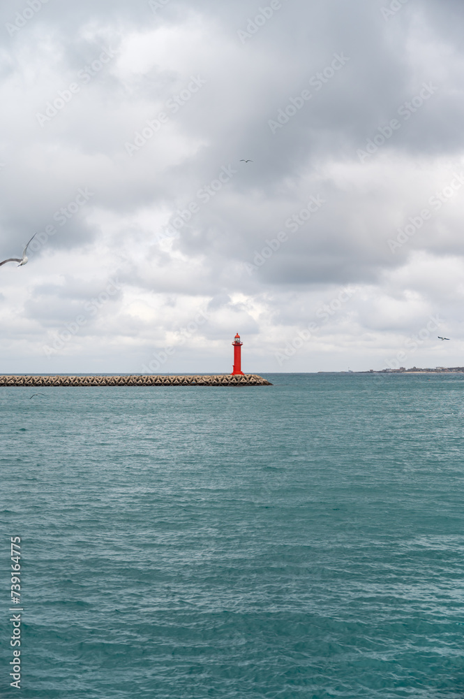 The red lighthouse at sea.