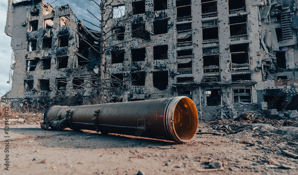 hand grenade launcher against the background of a destroyed house in Ukraine hand grenade launcher against the background of a destroyed house in Ukraine