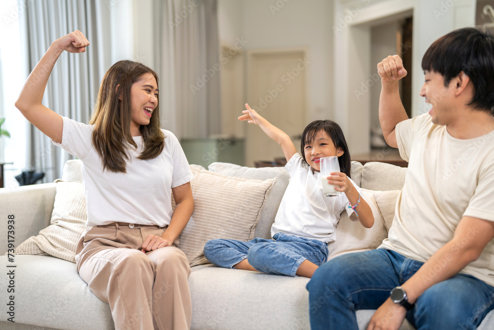 Portrait of enjoy happy love asian healthy family father and mother with asian girl smiling and having protein breakfast drinking hold glasses of milk, nutrition, calcium, vitamin at home Portrait of enjoy happy love asian healthy family father and mother with asian girl smiling and having protein breakfast drinking hold glasses of milk, nutrition, calcium, vitamin at home