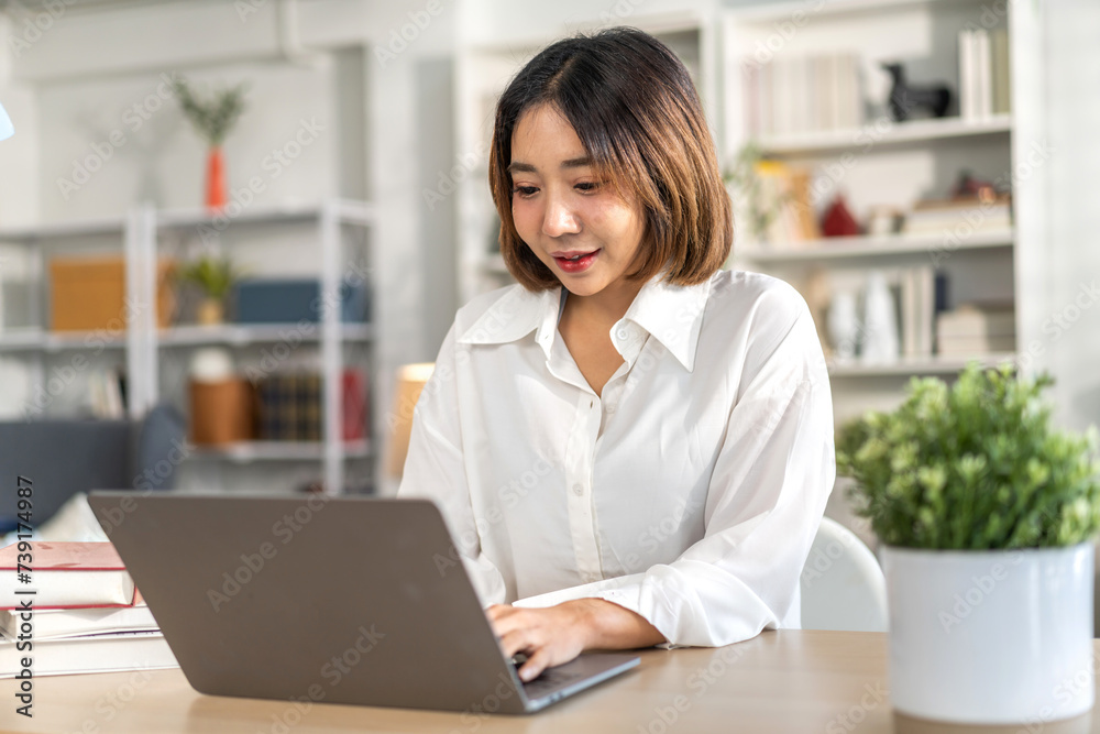 Young smiling asian woman happy relax use laptop conference work,learning, education, shopping, study online, webinar, online marketing, business, blog, digital internet advertising at home Young smiling asian woman happy relax use laptop conference work,learning, education, shopping, study online, webinar, online marketing, business, blog, digital internet advertising at home