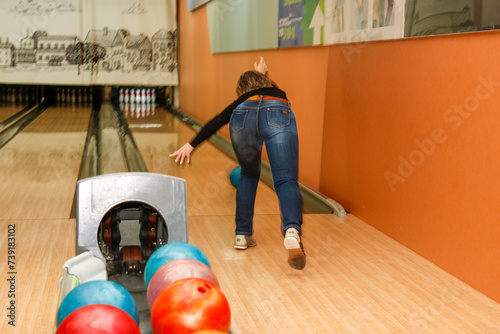 woman playing bowling, rear view