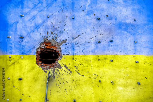 explosion damaged blue yellow house wall war in Ukraine photo