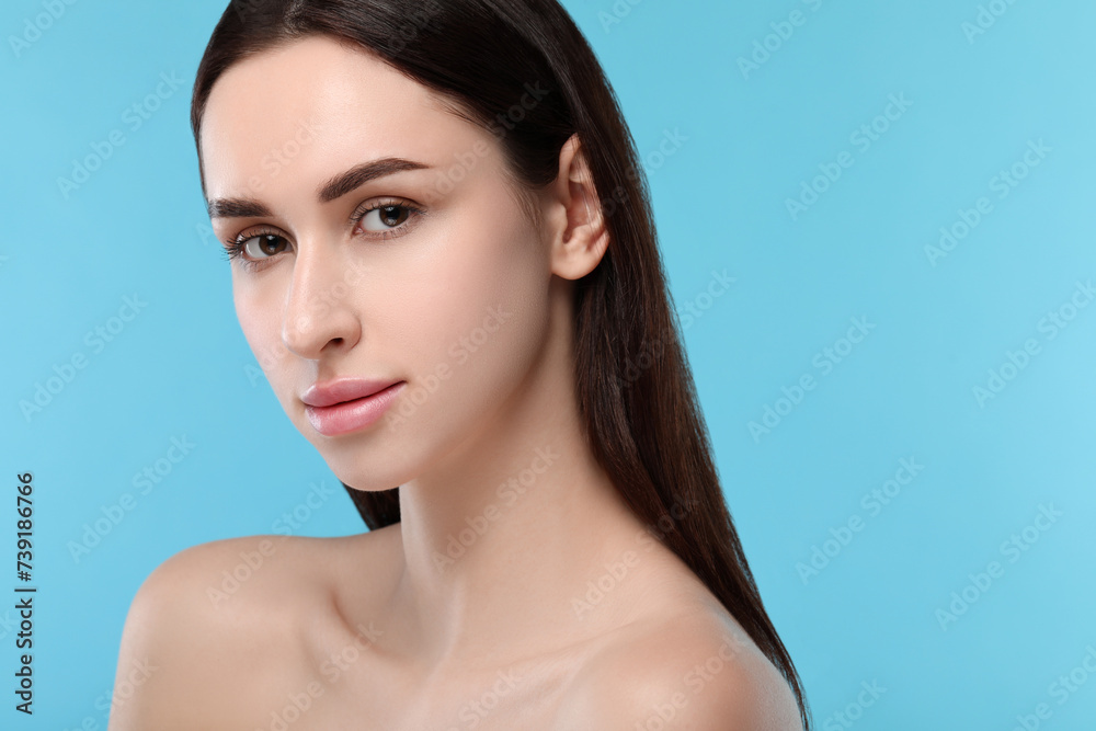 Portrait of beautiful young woman on light blue background. Space for text Portrait of beautiful young woman on light blue background. Space for text