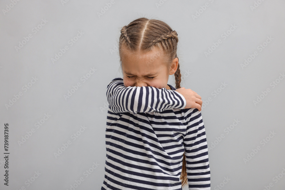 Sick girl coughing on gray background. Cold symptoms Sick girl coughing on gray background. Cold symptoms