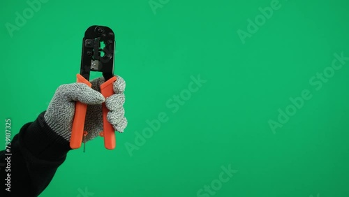 Tool for crimping RJ-45 connectors 8P8C, twisted pair crimper for crimping connectors on a green background. photo