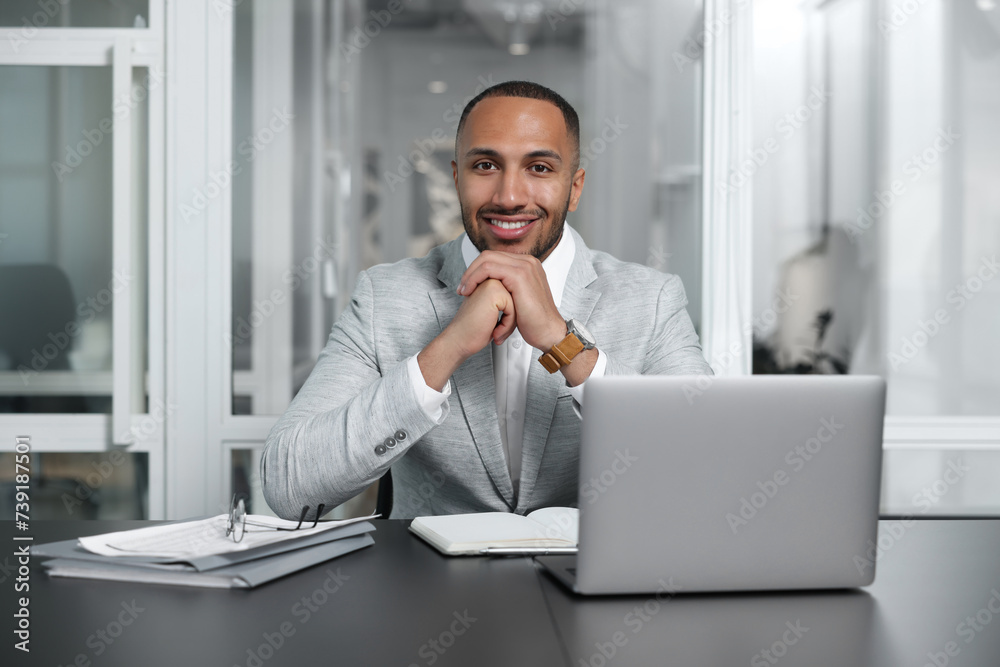 Happy man working at table in office. Lawyer, businessman, accountant or manager Happy man working at table in office. Lawyer, businessman, accountant or manager