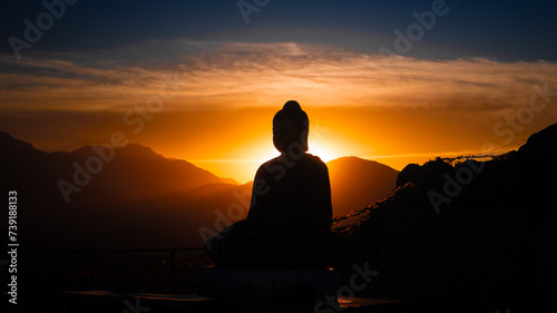 silhouette of buddha in sunset