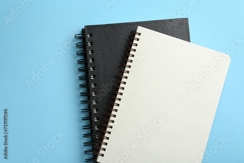 Notebooks on black background, top view. Space for text