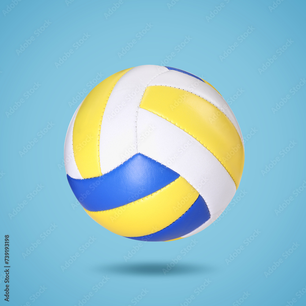 One volleyball ball in air on light blue background