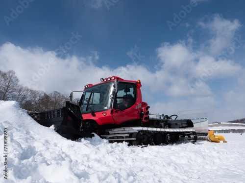 冬の青空と赤い圧雪車
