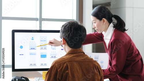 Website designer, Creative planning phone app development template layout framework wireframe design, Young asian woman and man UX designer working on smartphone application at office