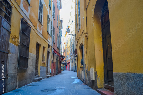 Nice, France, 02/13/2024: The architecture of the old town in Nice boasts a blend of Italian style with French motifs, characterized by colorful houses and narrow streets. photo