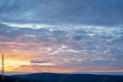 bright sunrise in the mountains with blue sky