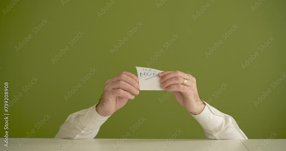 a man's hands find and present the note with the word I make money