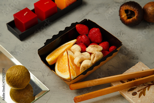 a strawberry and sliced orange and banana