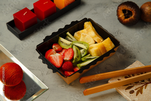 a pineapple, a strawberry and kiwi