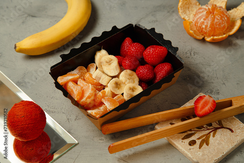 banana, strawberry and mandarin slices in the composition