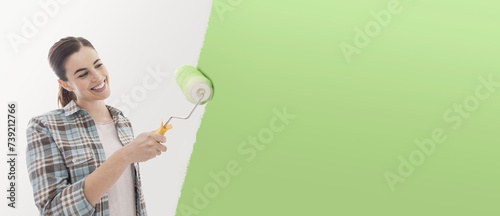 Young woman painting her house