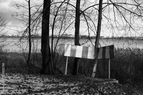 Fototapeta Naklejka Na Ścianę i Meble -  Old broken road sign in the winter forest
